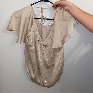 women's cream vneck with sequin details and tie.